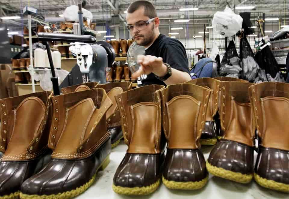 FILE-In this Dec. 14, 2011 file photo, Eric Rego stitches boots in the facility where LL Bean boots are assembled in Brunswick, Maine. LL Bean CEO Chris McCormick told workers that the Maine-based retailer has been conservative for the past few years and is now ready to "accelerate our growth plans and grab market share." That plan includes pumping an additional $100 million into its website, retail expansion and business systems, he said. (AP Photo/Pat Wellenbach, files)