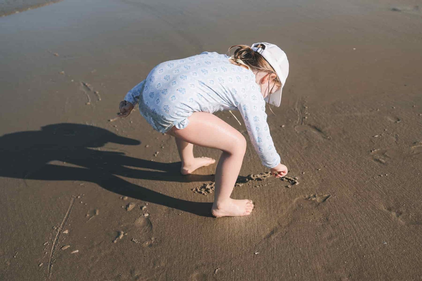 Toddler writing on sand Toddler writing on sand